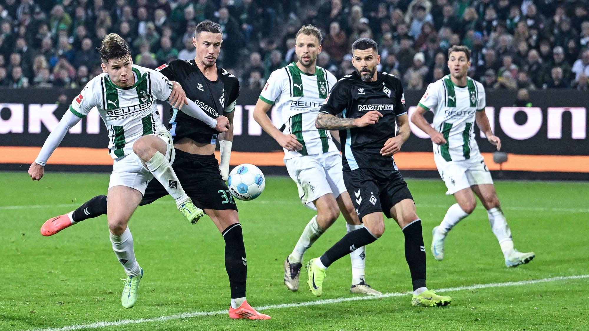 Die Gladbach-Profis Lukas Ullrich, Marvin Friedrich und Joe Scally gehen im Spiel gegen Werder Bremen zum Ball.