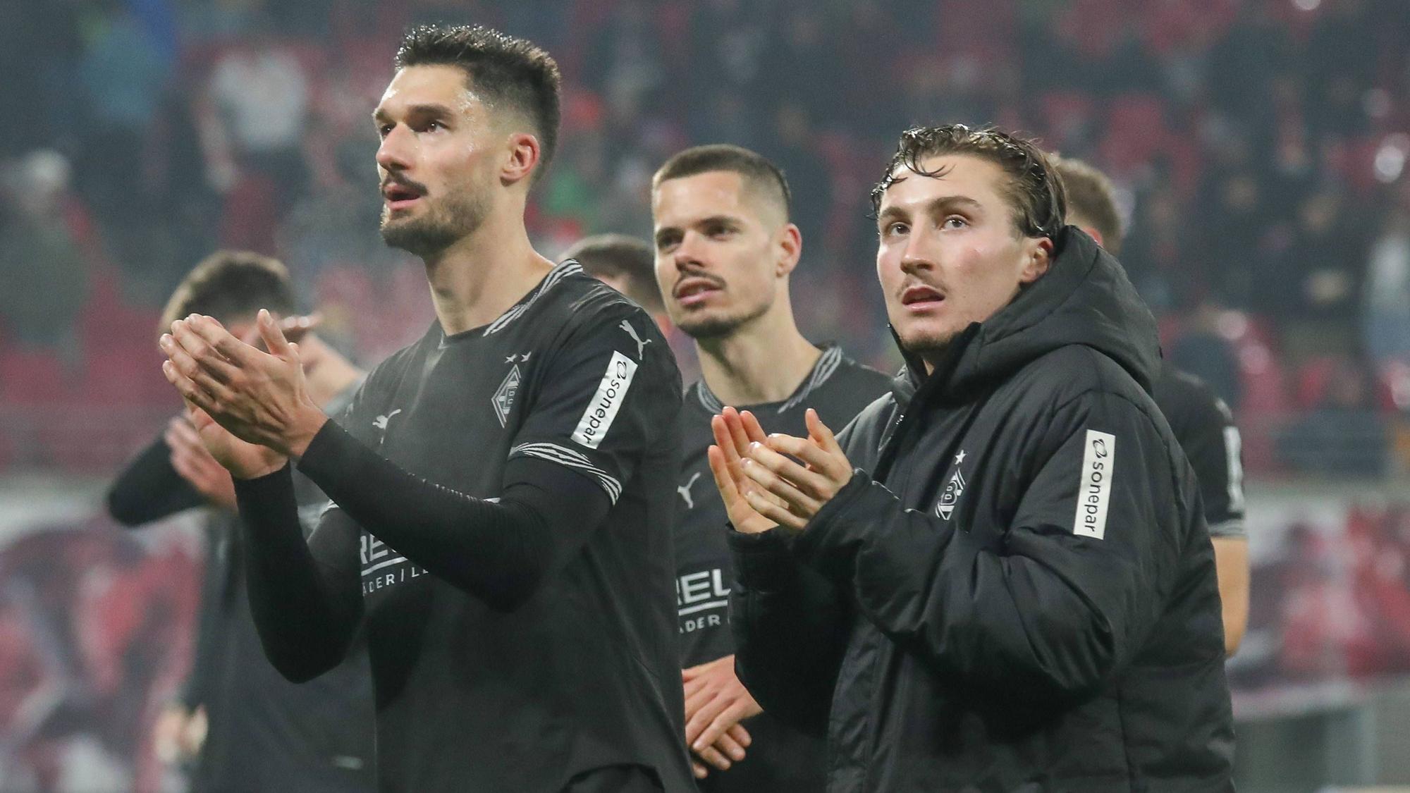 Tim Kleindienst, Julian Weigl und Rocco Reitz applaudieren den mitgereisten Fans von Borussia Mönchengladbach nach dem Auswärtsspiel in der Bundesliga bei RB Leipzig.