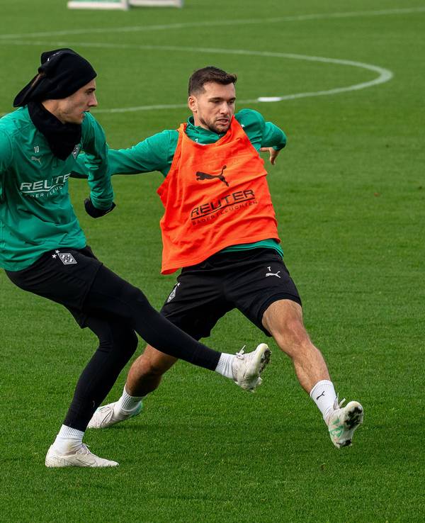 Borussia Mönchengladbachs Florian Neuhaus passt den Ball im Training, Teamkollege Kevin Stöger versucht zu blocken.
