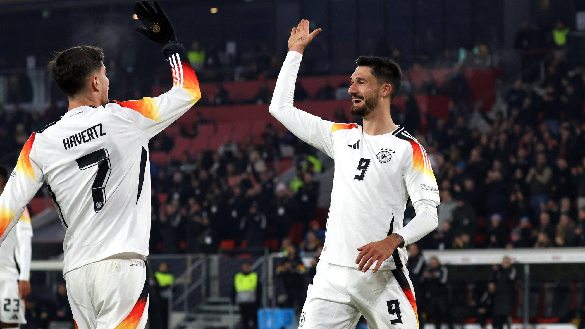 Tim Kleindienst klatscht mit Kai Havertz ab.