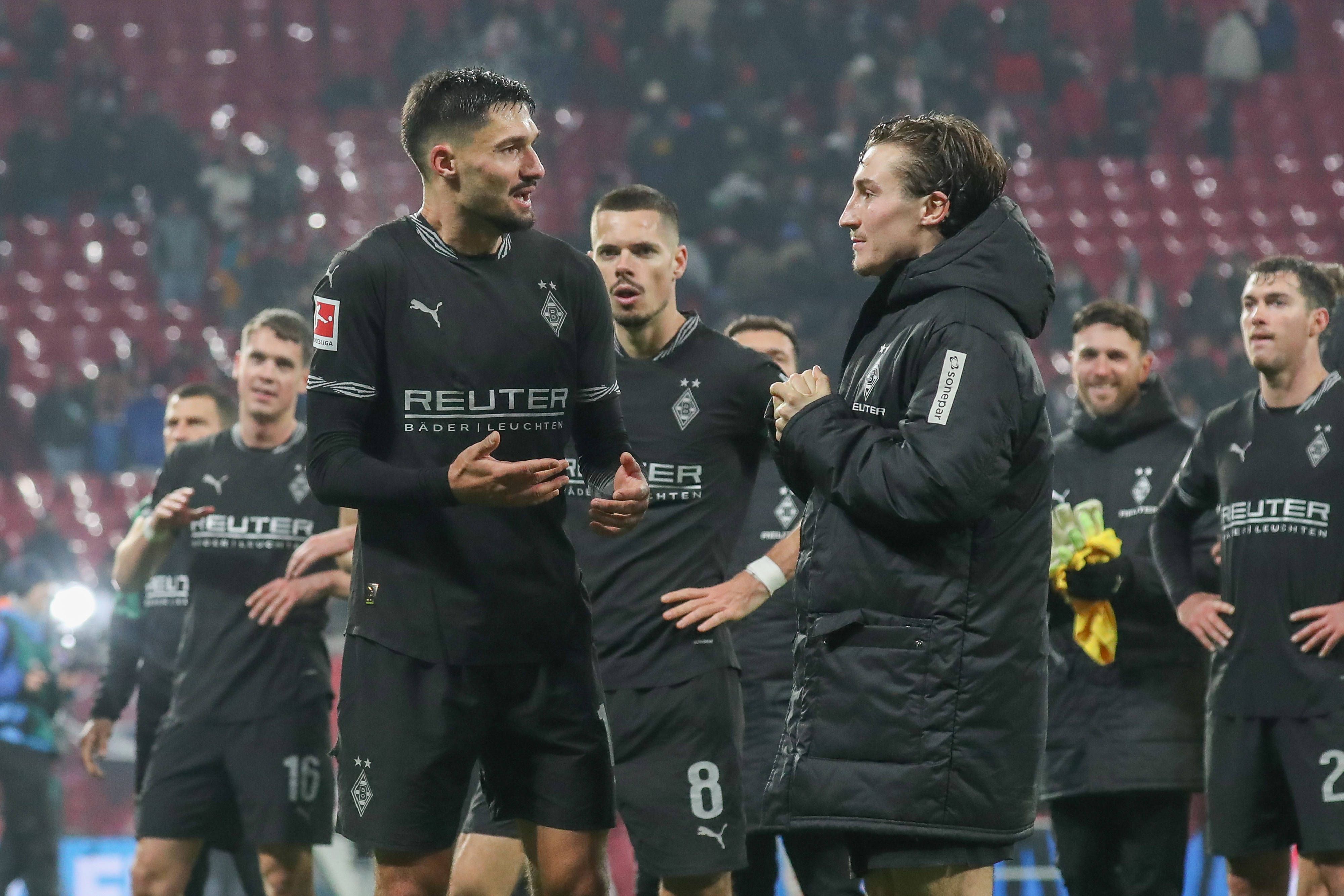 Die Gladbach-Profis Tim Kleindienst und Rocco Reitz unterhalten sich nach dem Spiel bei RB Leipzig auf dem Platz.