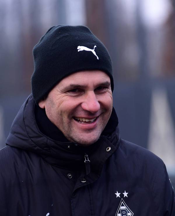 Borussia Mönchengladbachs Trainer Gerardo Seoane läuft lachend auf den Trainingsplatz.