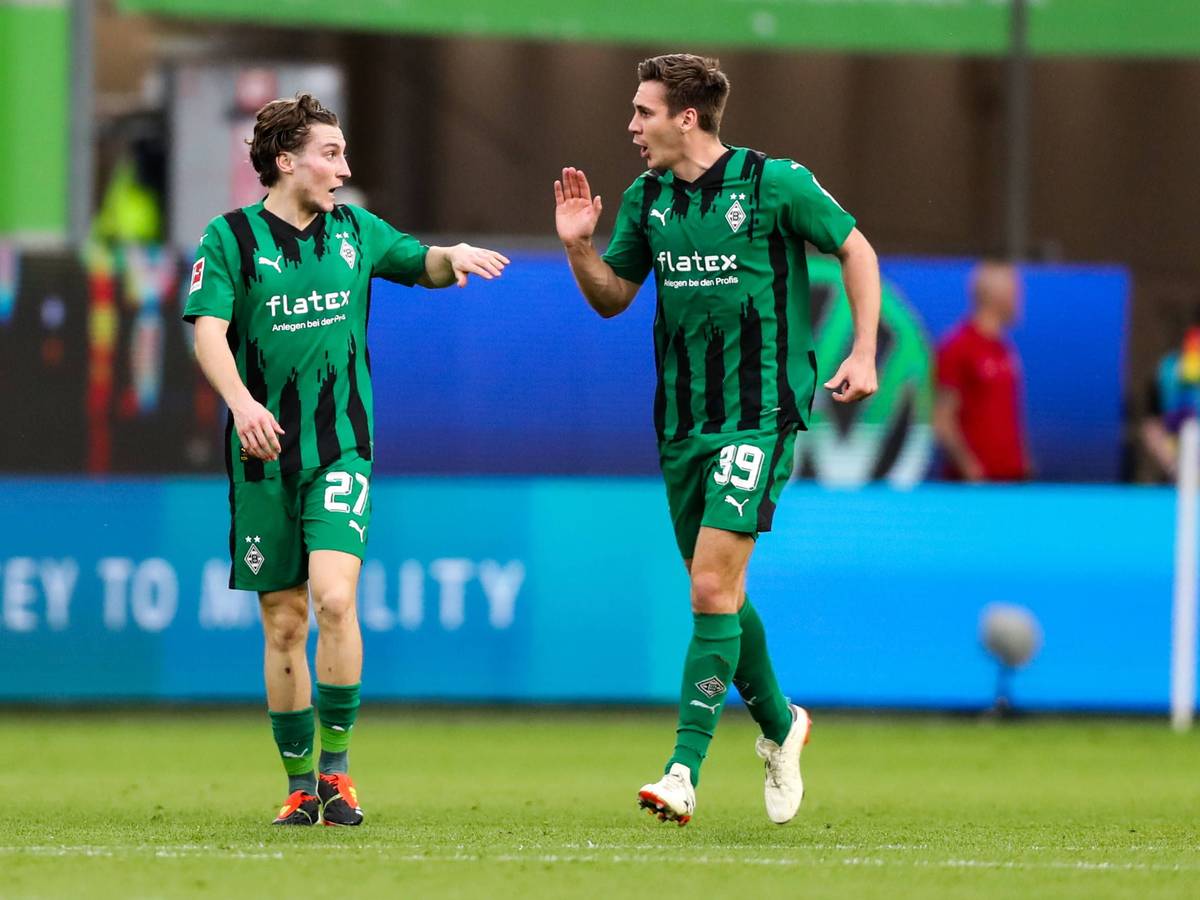Die Gladbach-Profis Rocco Reitz und Maximilian Wöber klatschen sich im Bundesliga-Spiel beim VfL Wolfsburg ab.