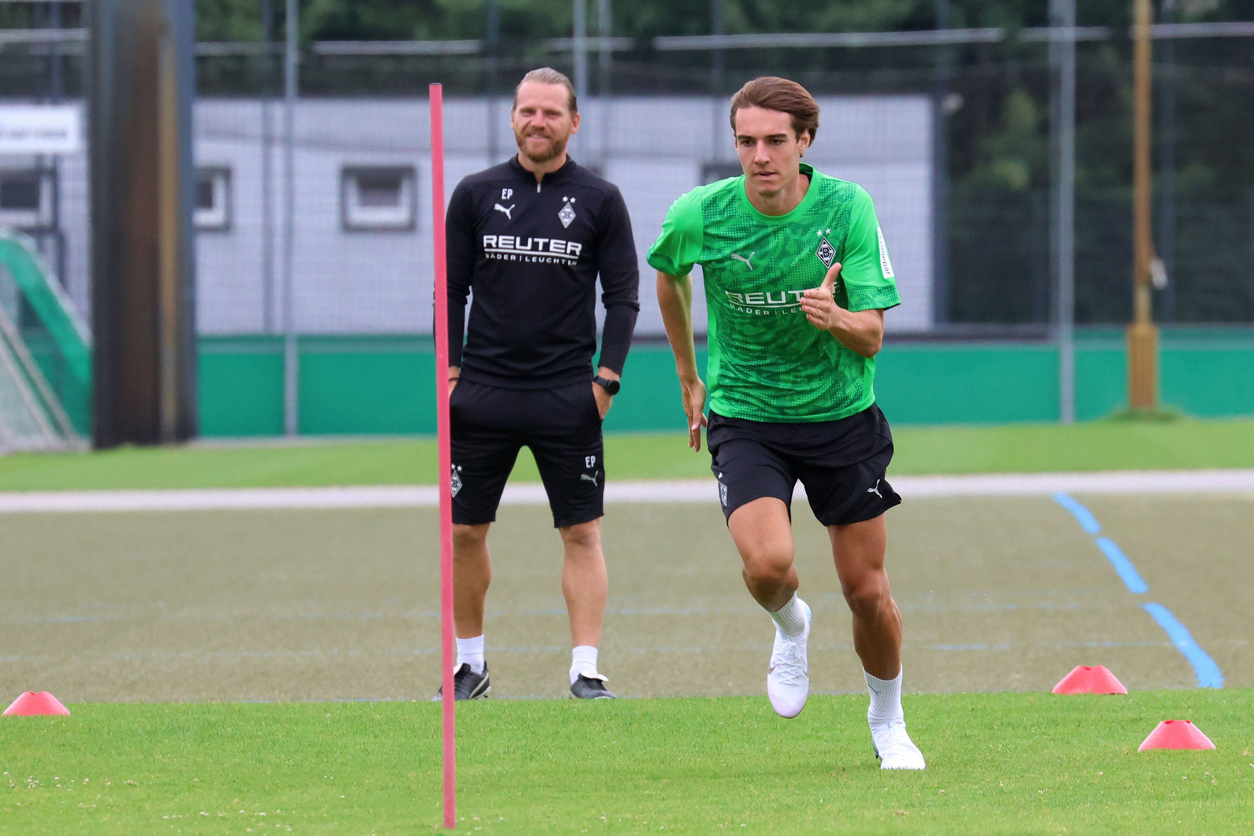 Florian Neuhaus bei einer Trainingseinheit mit U23-Coach Eugen Polanski im Hintergrund.