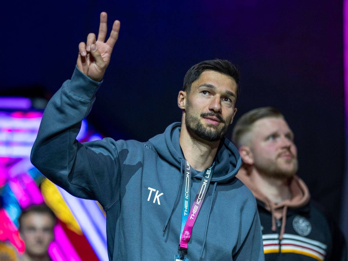 Tim Kleindienst zeigt das Peace-Zeichen zu den Fans in einer Halle.