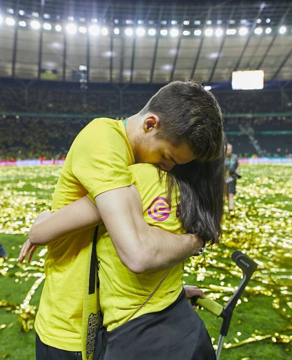 Julian Weigl umarmt Sarah Richmond.