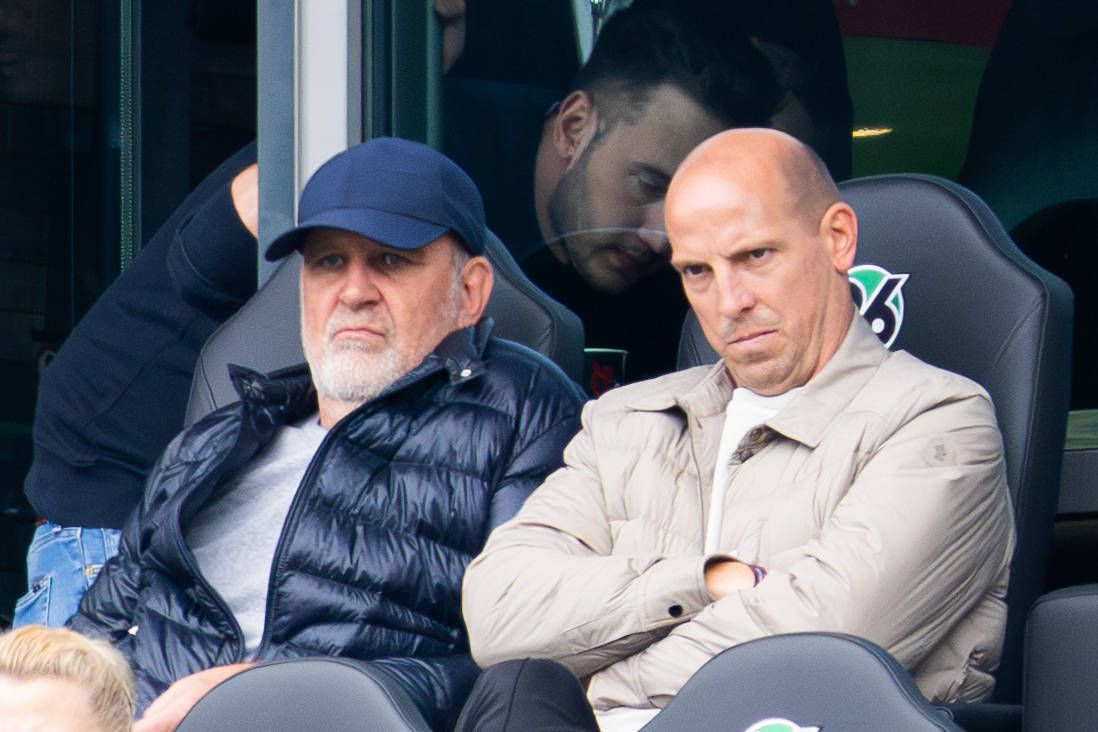 Jörg Schmadtke und Jan Schlaudraff schauen etwas finster auf der Tribüne.