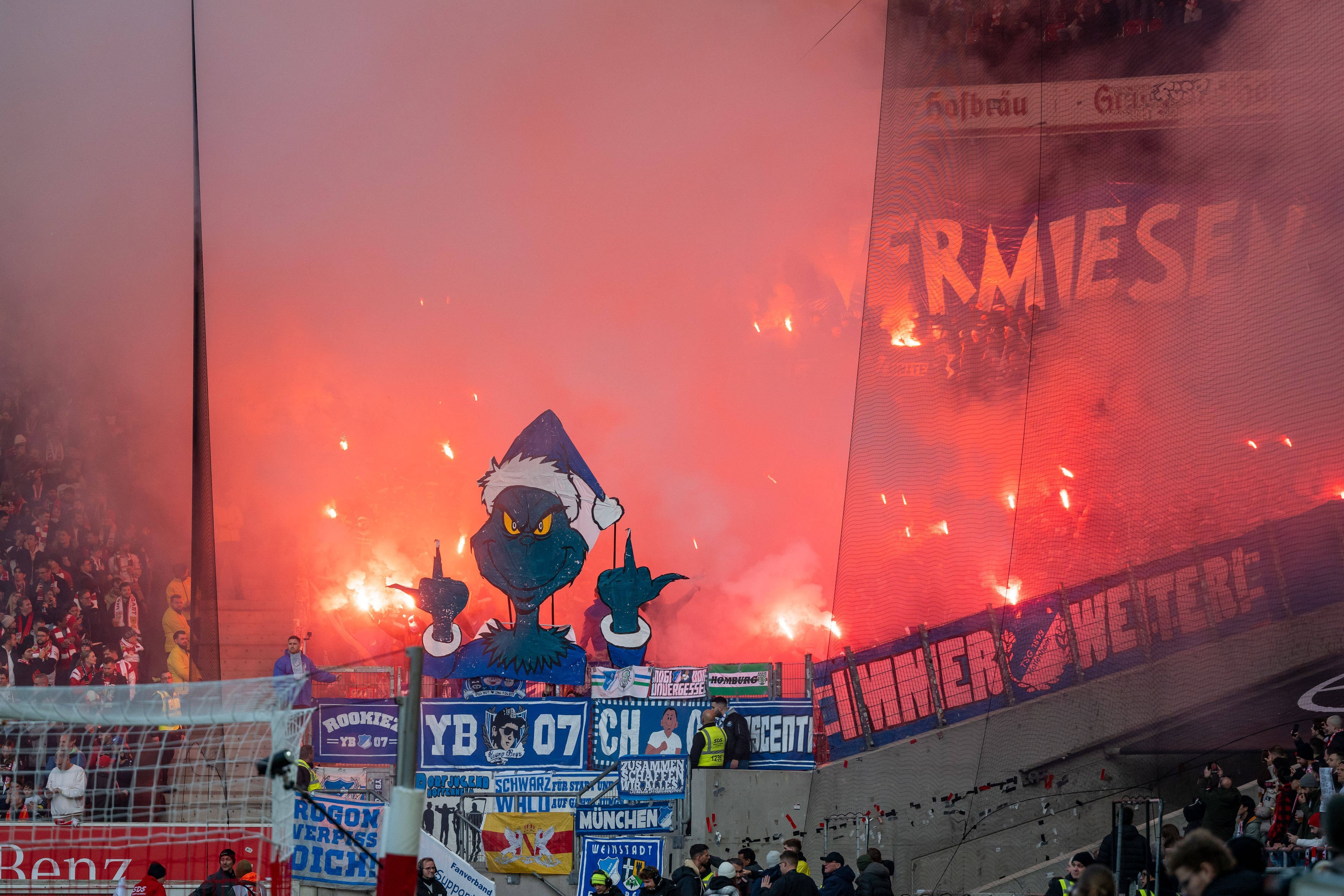 Hoffenheim-Fans zeigen einen Grinch, der beide Mittelfinger in die Luft streckt.