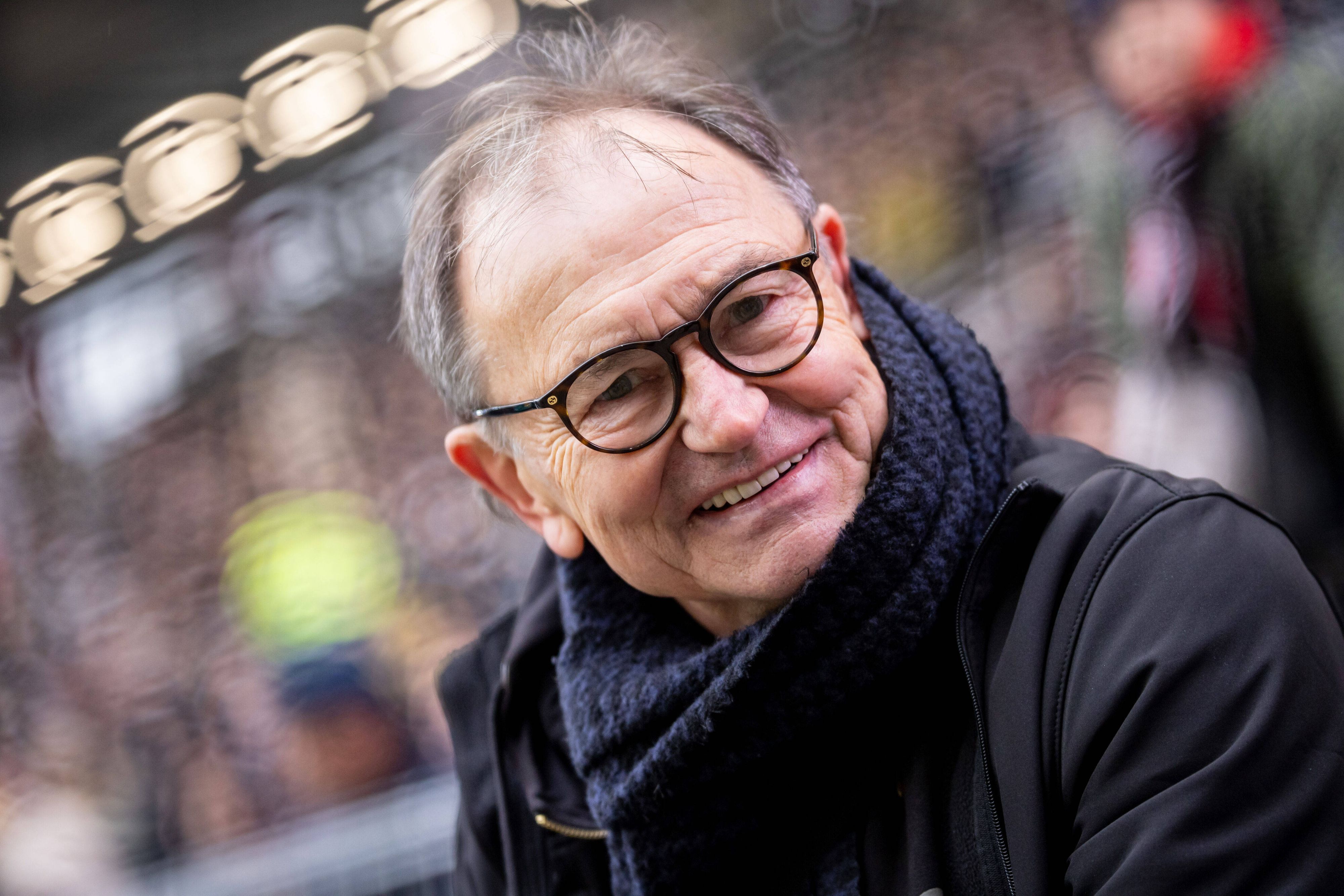 Ewald Lienen mit Brille. Er lächelt in die Kamera.
