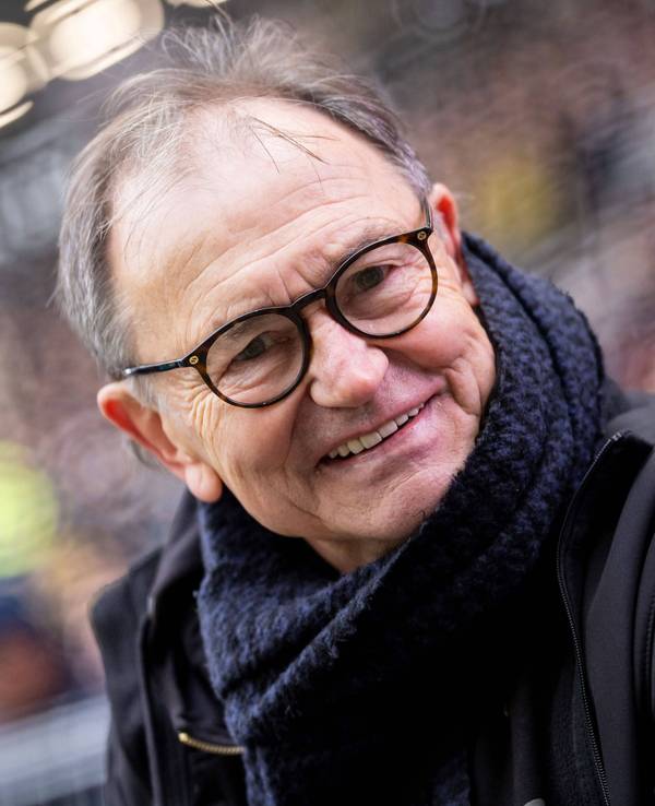 Ewald Lienen mit Brille. Er lächelt in die Kamera.