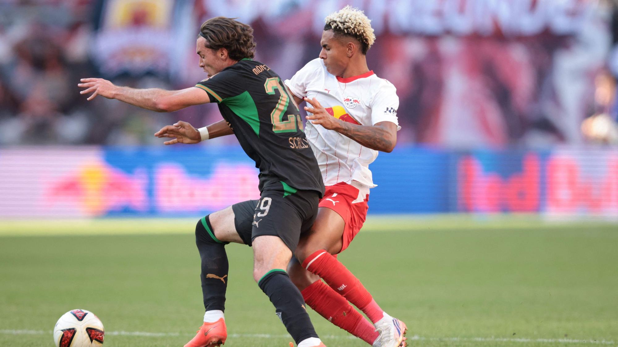 Gladbachs Joe Scally kämpft mit Antonio Nusa von RB Leipzig um den Ball.
